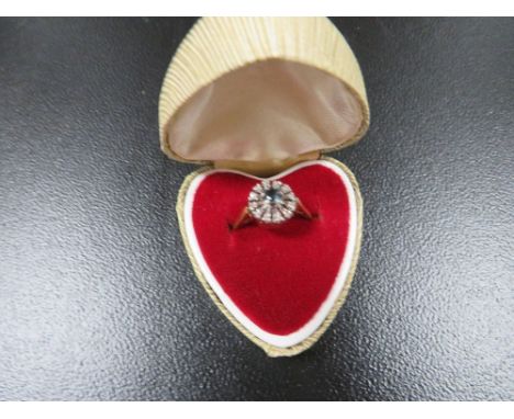 A hallmarked 18ct gold ring set with an aquamarine stone surrounding with diamonds approx. weight 4.2g 