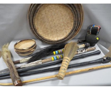 A quantity of African tribal items to include a beaded Zulu stabbing spear, a beaded staf fly whip, shallow wicker bowls etc 