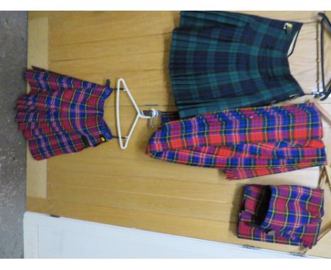 Three kilts to include two McPherson kilts and a Blackwatch kilt - size 34" waist together with a plaid (4)