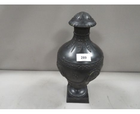 A Wedgwood black Basalt lidded urn - lid damaged with typical classical vignettes and musical instrument decorated on square 