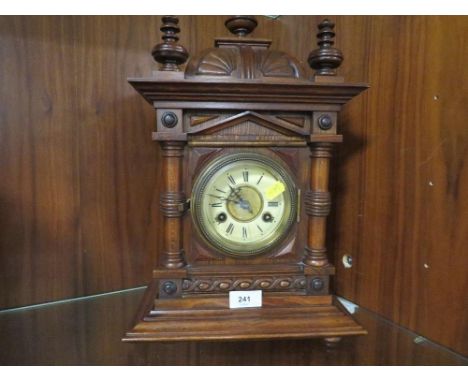A carved wooden mantle clock 