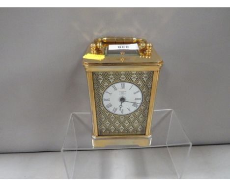 A Halcyon Days enamelled decorated carriage clock with key 