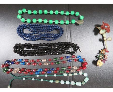 A quantity of antique bead necklaces, including jade types