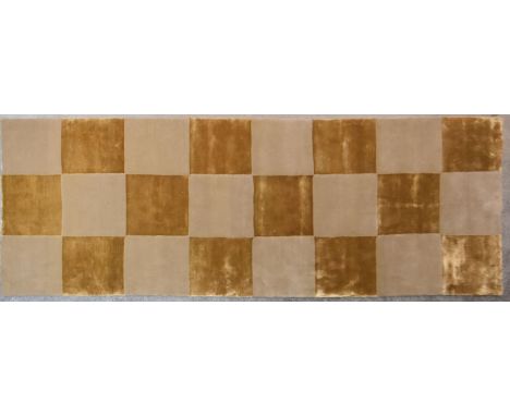 A silk and wool runner with gold and beige chequerboard design. L.300x110cm