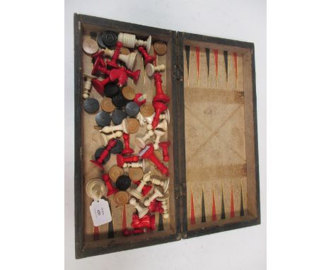 A travelling chess and backgammon board with bone chess pieces  