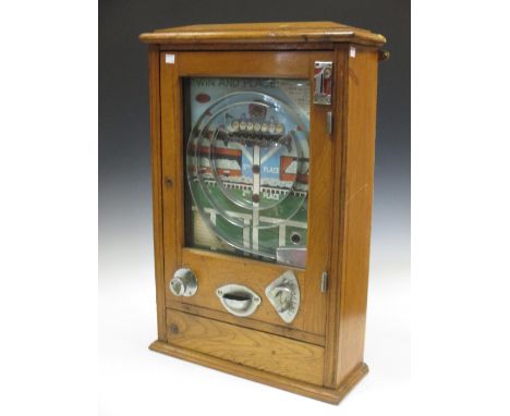 A 'Win a place' 1d slot machine, wall mounted in an oak case and another coin opperated game by ESCO  