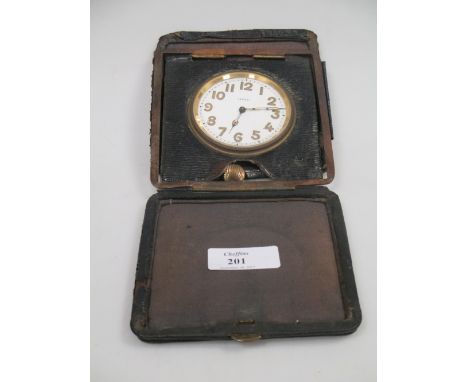 An Asprey bedside travel clock in a damaged leather case, early 20th century.  