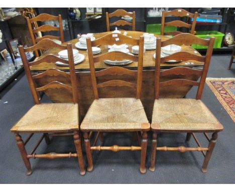 Eight rush seated ladder back dining chairs  