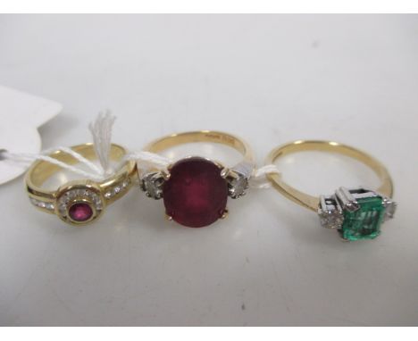 An 18ct pale emerald cut emerald (damaged) and diamond ring, size P: an 18ct ruby (untested) and diamond ring, size P: and a 