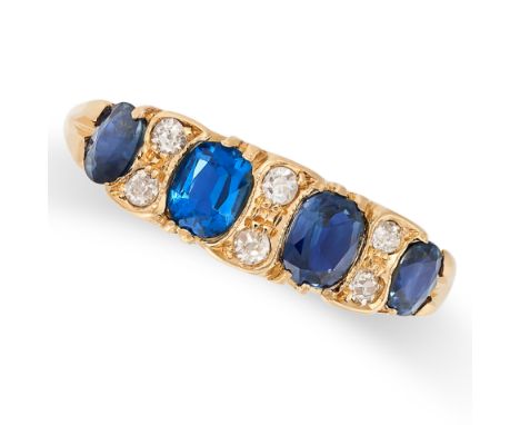 AN ANTIQUE SAPPHIRE AND DIAMOND RING in 18ct yellow gold, set with four cushion and oval cut sapphires punctuated by pairs of