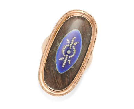 AN ANTIQUE ENAMEL AND PEARL MOURNING RING in yellow gold, the oval face with a navette shaped motif set with blue enamel and 