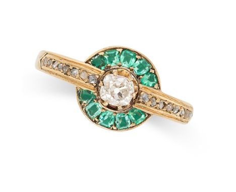 AN EMERALD AND DIAMOND RING set with an old cut diamond in a border of cushion cut emeralds, the band accented by rose cut di