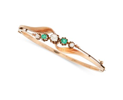 AN EMERALD AND DIAMOND BANGLE in yellow gold, the hinged body set with old cut and round brilliant cut diamonds and round cut