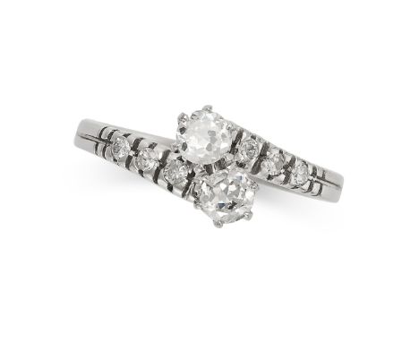 A DIAMOND TOI ET MOI RING in 18ct white gold, set with two round brilliant cut diamonds on a band set with trios of round bri