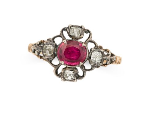 AN ANTIQUE RUBY AND DIAMOND RING in yellow gold and silver, set with a cushion cut ruby in an openwork border set with four o