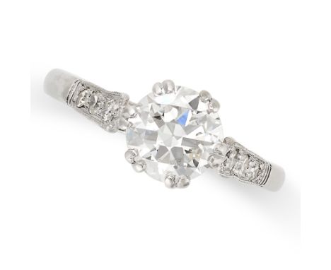 A SOLITAIRE DIAMOND RING in platinum, set with an old European cut diamond of approximately 1.02 carats, the band set with tr