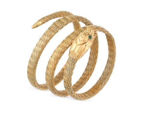 AN ANTIQUE EMERALD SNAKE BANGLE in yellow gold, designed as a snake coiled around itself, the body formed of woven gold, set 