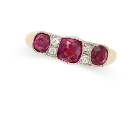 A RUBY AND DIAMOND RING set with three cushion cut rubies totalling approximately 1.80 carats accented by pairs of old cut di