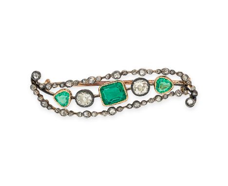 AN ANTIQUE EMERALD AND DIAMOND BROOCH in yellow gold, in scrolling design set with octagonal cut and step cut emeralds and ol