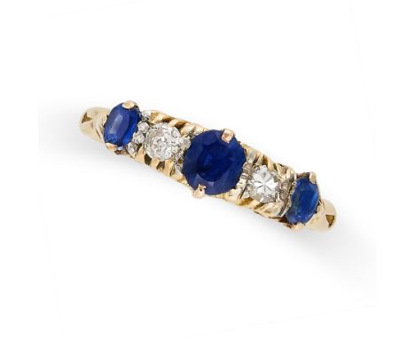 A VINTAGE SAPPHIRE AND DIAMOND RING in 18ct yellow gold, set with three cushion cut sapphires punctuated by two round cut dia