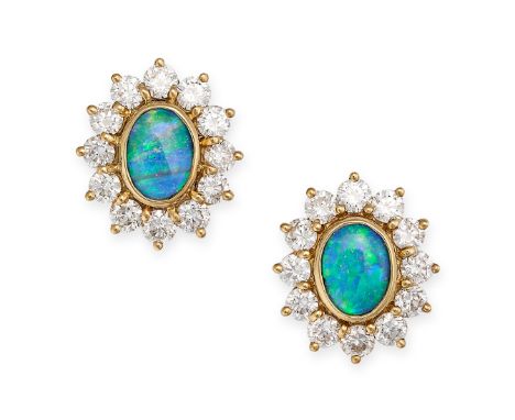 A PAIR OF BLACK OPAL AND DIAMOND STUD EARRINGS in yellow gold, each set with an oval cabochon opal within a border of round b