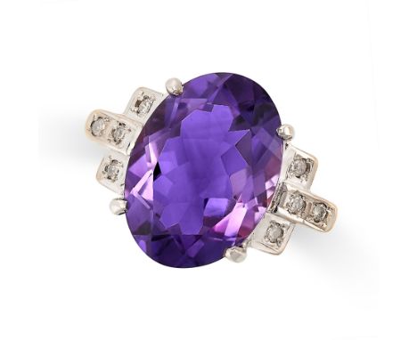 AN AMETHYST AND DIAMOND DRESS RING in yellow gold and white gold, set with an oval cut amethyst between stepped shoulders set