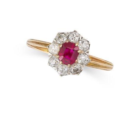 A RUBY AND DIAMOND CLUSTER RING in yellow gold and platinum, set with a step cut ruby of 0.66 carats within a cluster of old 