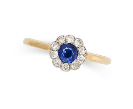 A SAPPHIRE AND DIAMOND RING in 18ct yellow gold, set with a round cut sapphire of 0.42 carats in a border of single cut diamo