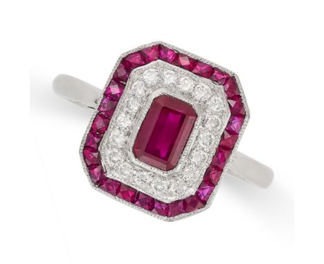 A RUBY AND DIAMOND DRESS RING in white gold, the octagonal face set to the centre with an octagonal step cut ruby in a concen