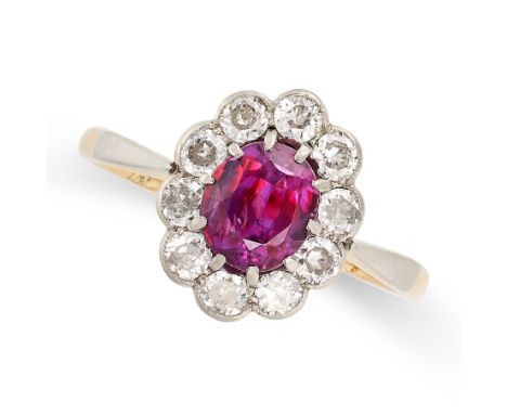 AN UNHEATED RUBY AND DIAMOND CLUSTER RING in 18ct yellow gold and platinum, set with an oval cut ruby of 1.42 carats within a