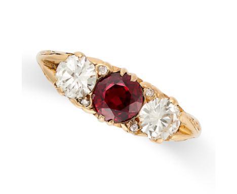 A VINTAGE THREE STONE RUBY AND DIAMOND RING in 18ct yellow gold, set with a round cut ruby of approximately 0.97 carats betwe