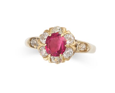 AN ANTIQUE RUBY AND DIAMOND DRESS RING in yellow gold, set with a cushion cut ruby of approximately 1.0 carats, within a bord