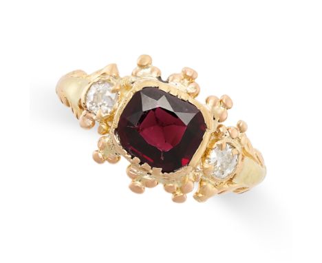 A GARNET AND DIAMOND RING in 18ct yellow gold, set with a cushion cut garnet between two old cut diamonds, stamped 18CT, size