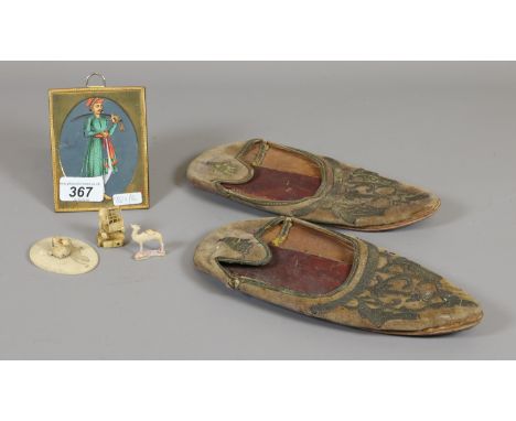 A pair of eastern embroidered pumps, an Indian gouache on acetate portrait of a Mughal Prince and three small ivory carvings.