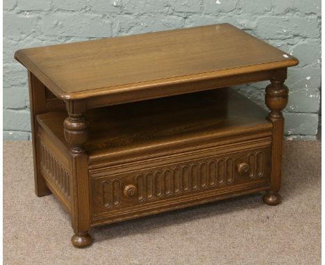 An Ercol drop leaf two tier single drawer corner television table.