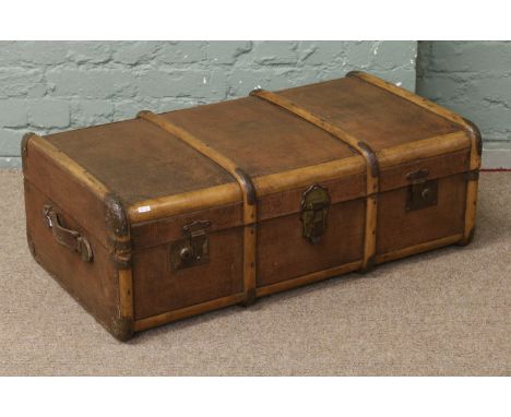 An early C20th wood bound leather travel trunk with leather handles.