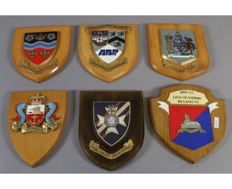 Six polychrome crests mounted on oak shield; Royal Lincolnshire regiment, the light dragoons etc.