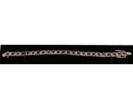 A silver line bracelet set with amethyst.