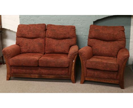 A red upholstered two seat sofa and armchairs.