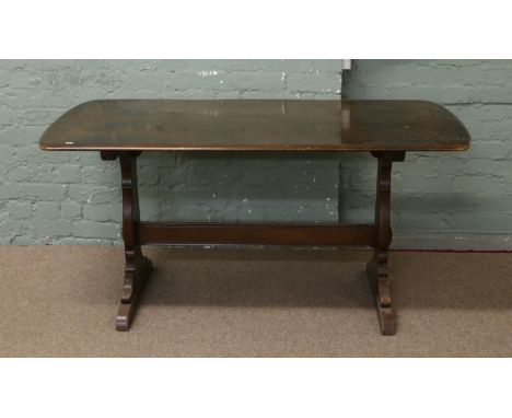 An Ercol dark oak refectory dining table.