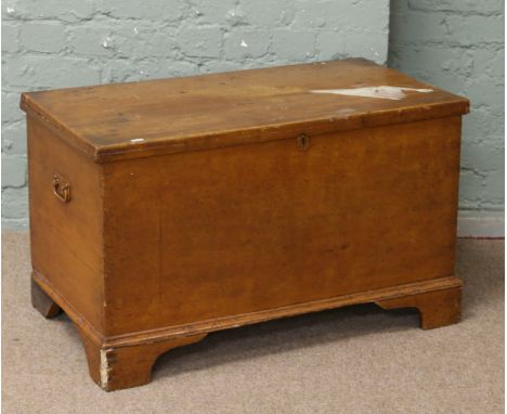 A painted Victorian pine blanket box raised on bracket feet.