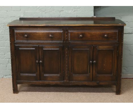 An Ercol dark oak sideboard.