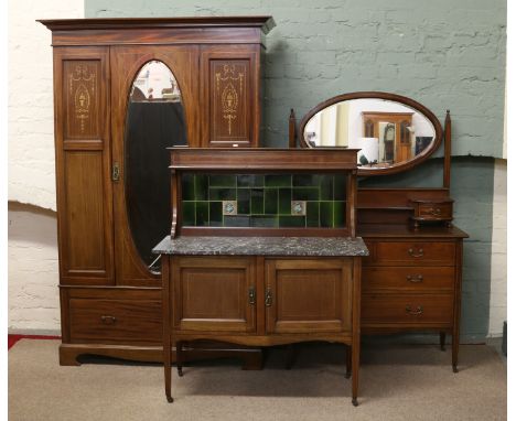 An Edwardian mahogany bedroom suite comprising; double wardrobe with inlaid panels, tile back wash stand and dressing chest.