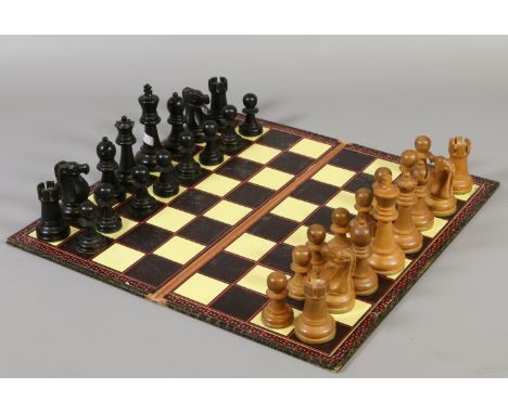 A Staunton pattern chess set opposing side ebonized, all weighted with associated board.