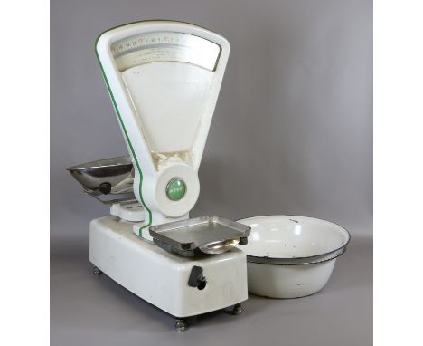 A pair of white enamel imperial Avery shop scales along with two white enamel bowls.