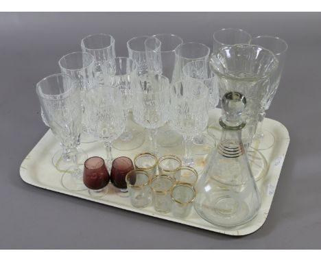 A tray of glassware to include decanter and matching shot glasses, champagne flutes etc.