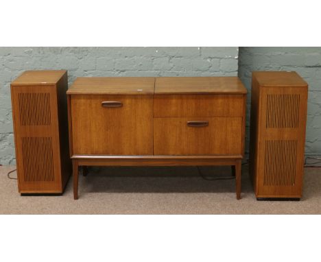 A Dynatron teak cased record player and radio along with two speakers.