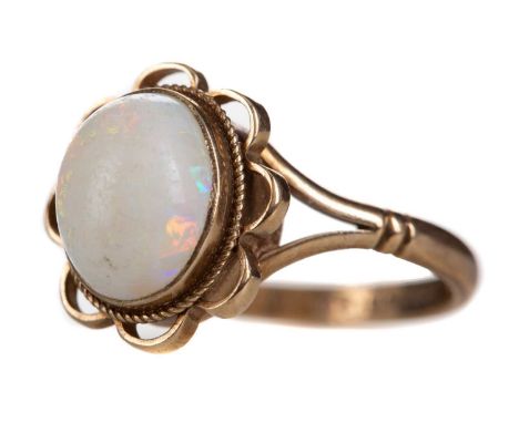 OPAL RING,the cabochon opal within an openwork border, in nine carat gold, size M, 2.8g