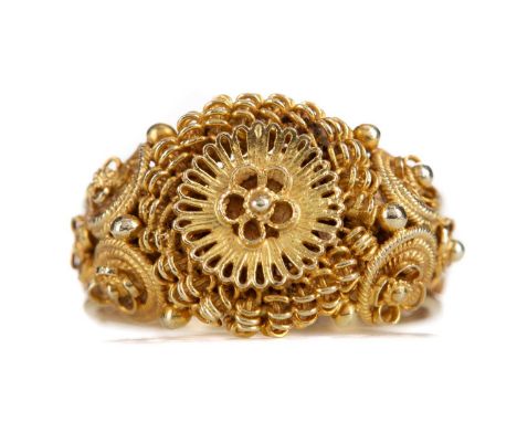 ORNATE GOLD RING,with central flower motif, to a woven effect shank, unmarked, size K 1/2, 5.4g