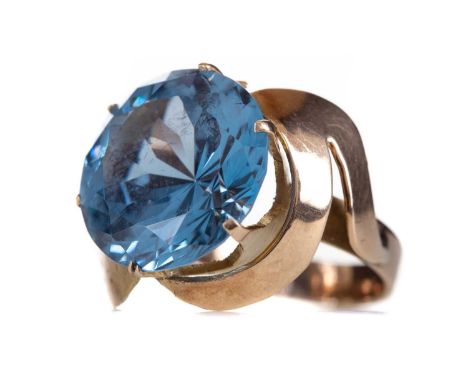 BLUE TOPAZ RING,the round gem to an abstract mount marked 14K, size J, 6.8g